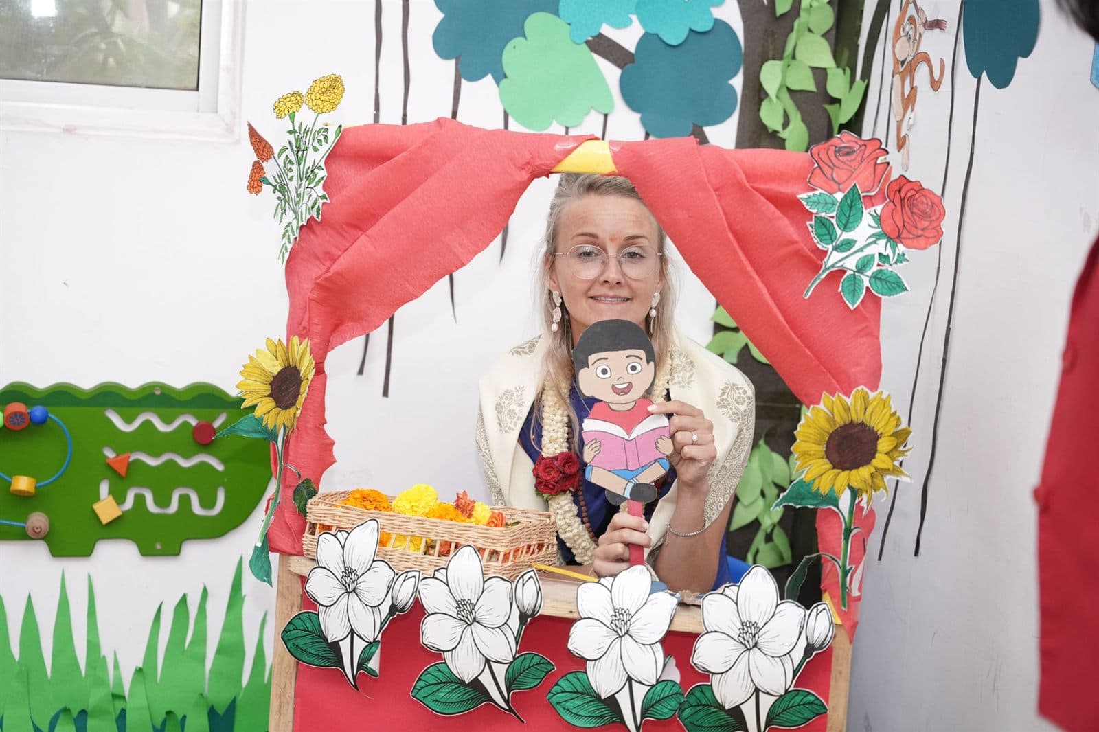 A Kalpaa educator telling a story from a hand-made puppet theatre